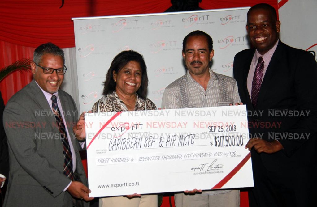 Second right, CEO Caribbean Sea and Air Marketing, Mark Forgenie,  receives a cheque from, at left, Minister of Agriculture Land and Fishries Clarence Rambharat, Minister of Trade and Industry Paula Gopee-Scoon and MP for Moruga/Tableland Dr Lovell Francis during a Moruga Hill Rice Grant Ceremony and Facility Tour, which took place in Moruga.
PHOTO BY ANIL RAMPERSAD.