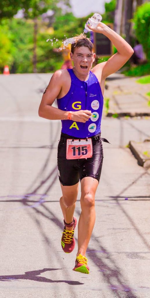 Tao Jouineau, of Guyana, takes part in the 5K run yesterday, in Tobago, in the 16-19  age category, at the 2018 Carifta Triathlon and Aquathlon Championships .