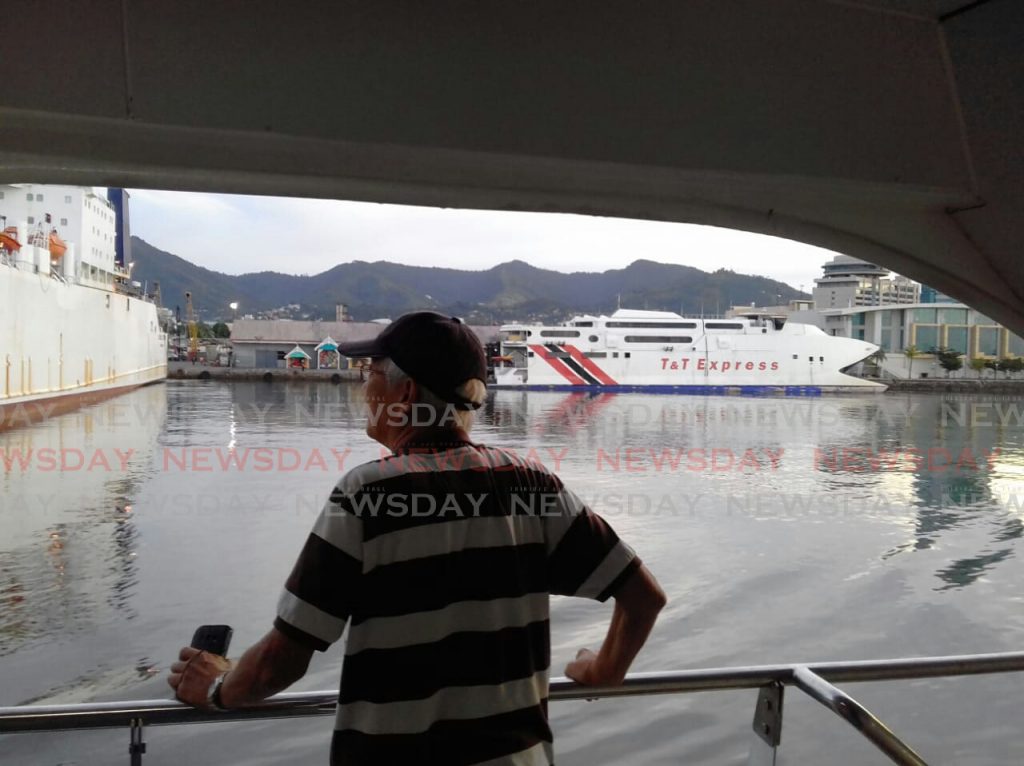 A passenger looks out at the Port of Port of Spain from aboard the Galleons Passage. The ferry began its maiden commercial voyage to Scarborough shortly after 6 am. Photo by Sureash Cholai
