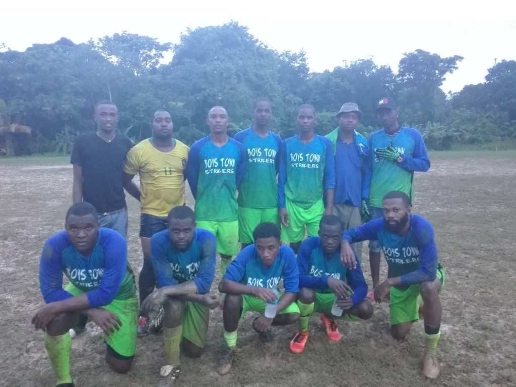 Boys Town players and manager Darryl Miranda celebrate a tough 1-0 win over Gremio, on Sunday, in the Caribbean Welders Fishing Pond Football League.