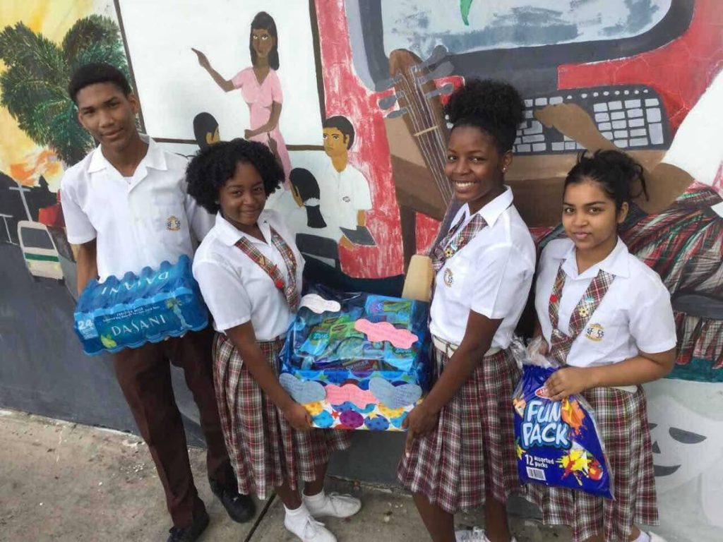 Members of  the Interact Club of San Fernando Central Secondary School donate hampers to children with autism and their families.