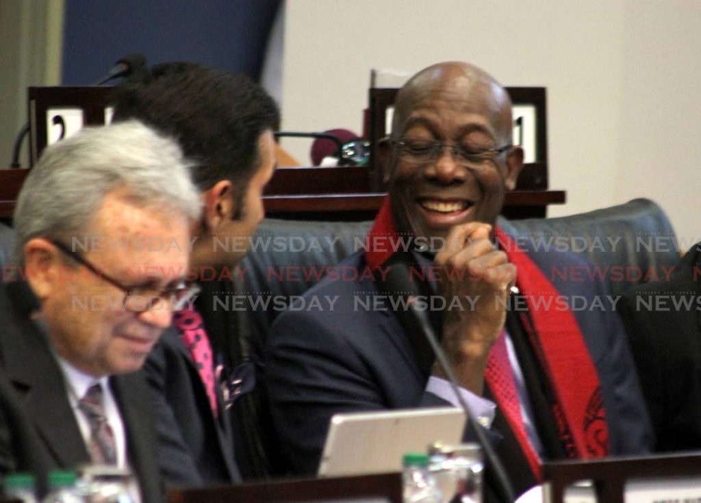 Prime Minister Dr Keith Rowley in a good mood alongside Attorney General Faris Al-Rawi, centre, and Finance Minister Colm Imbert, right, during the budget debate on Friday. PHOTO BY ROGER JACOB