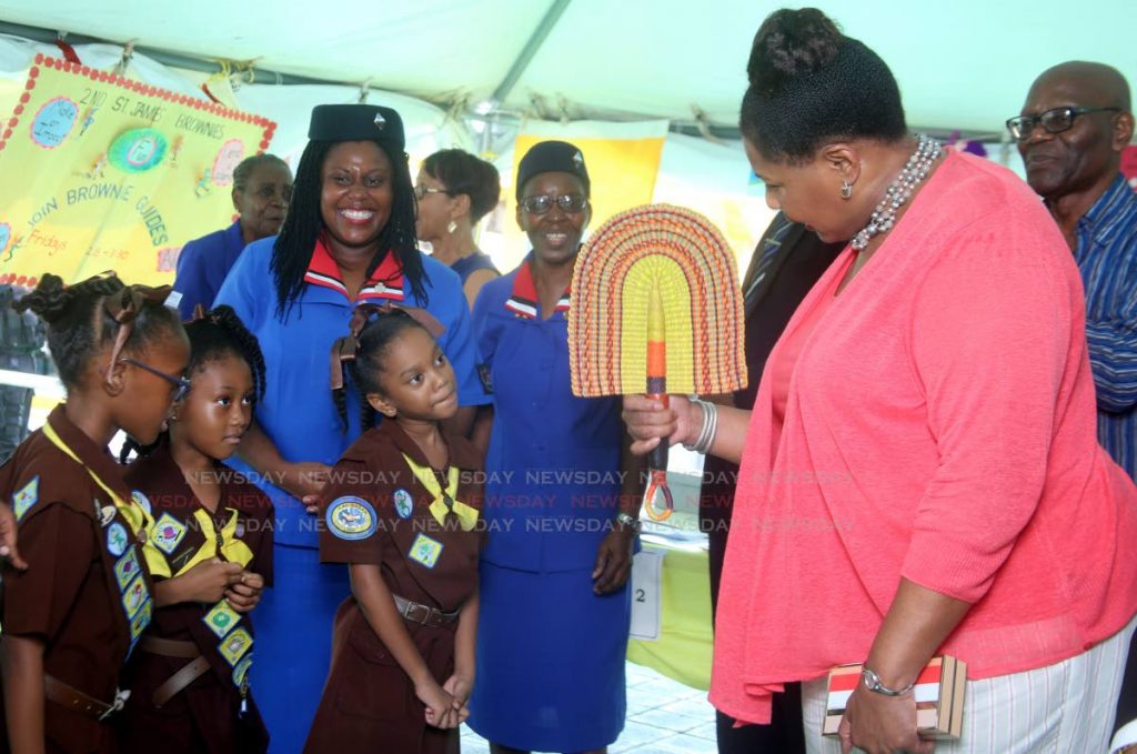 President Paula-Mae Weekes speaks to Brownies at their booth on Harris Promenade, San Fernando, to the delight of Division Commissioner Nadine Joseph, after a thanksgiving service of the Girl Guides Association. PHOTO BY VASHTI SINGH 