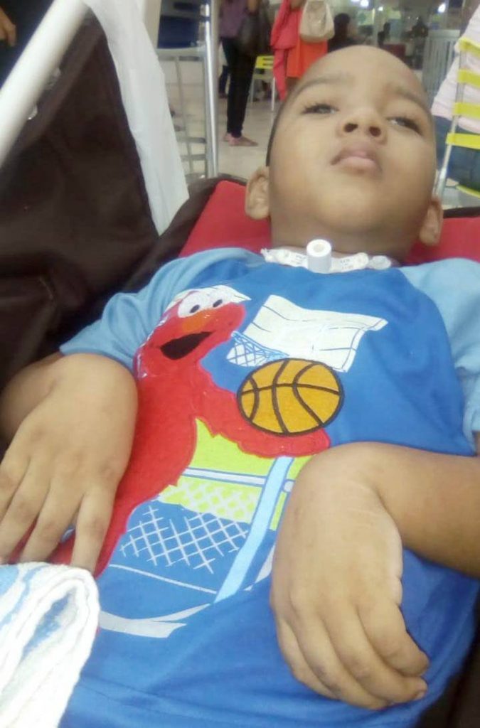 HELPLESS: Three-year-old Renaldo Cuffy, left virtually in a vegetative state after being treated at the Eric Williams Medical Sciences Complex in Mt Hope last year.