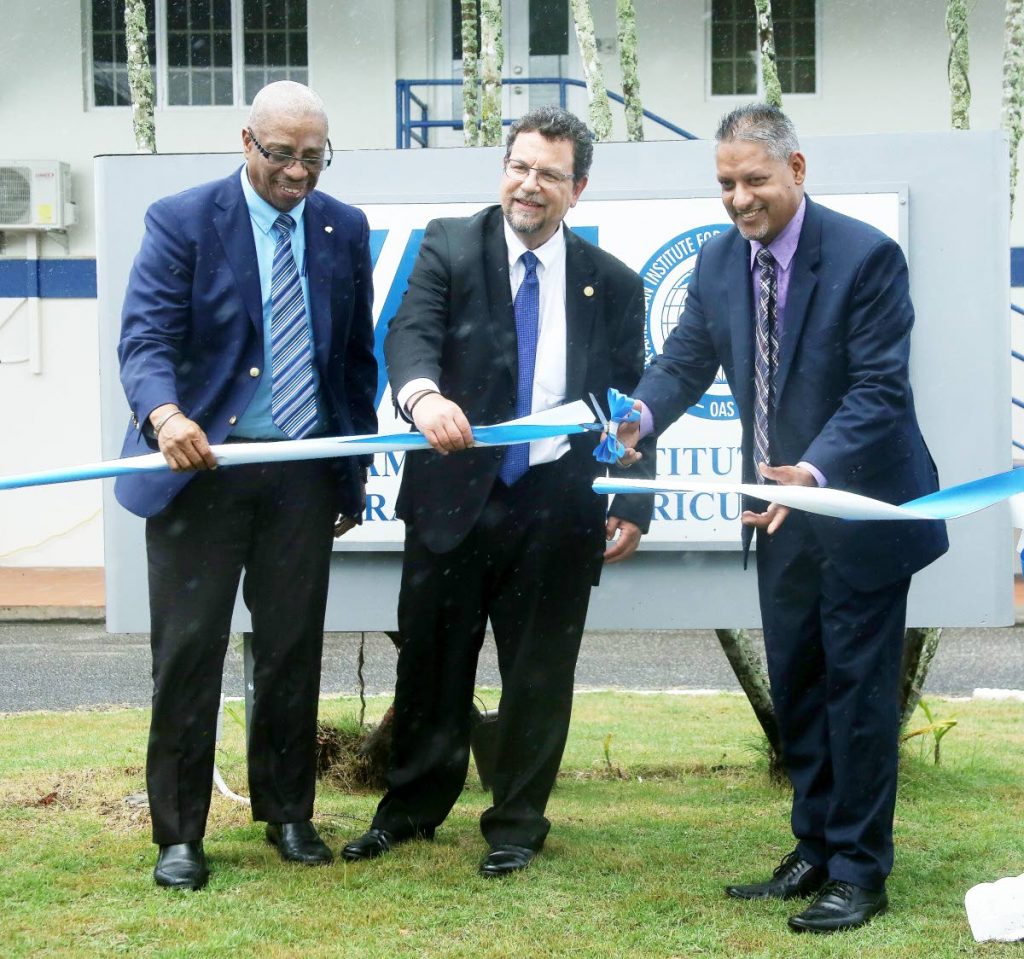 

Minister of Agriculture Clarence Rambharat cuts the ribbon with IICA director of management and regional integration Diego Montenegro, centre, and IICA TT representative Gregg C E Rawlins at the opening of the institute's office, Brechin Castle, Couva on Tuesday.