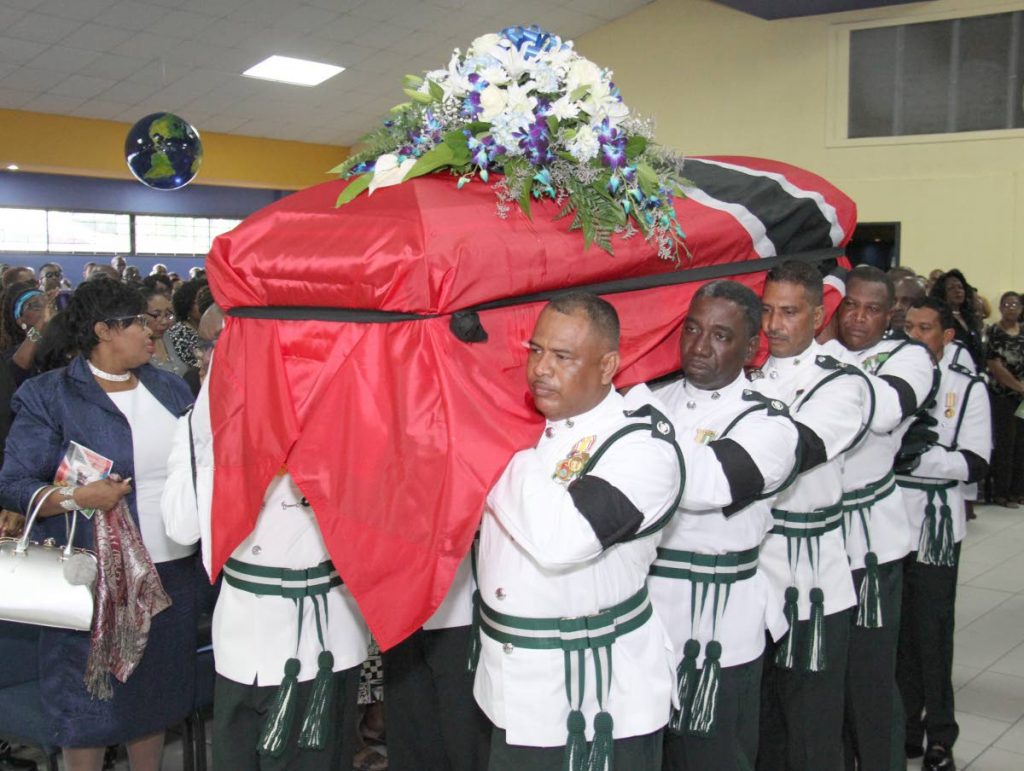 FINAL JOURNEY: Prison officers carry the casket of their fallen comrade, murdered Supt Wayne Jackson at his funeral yesterday in Arima. PHOTO BY ROGER JACOB