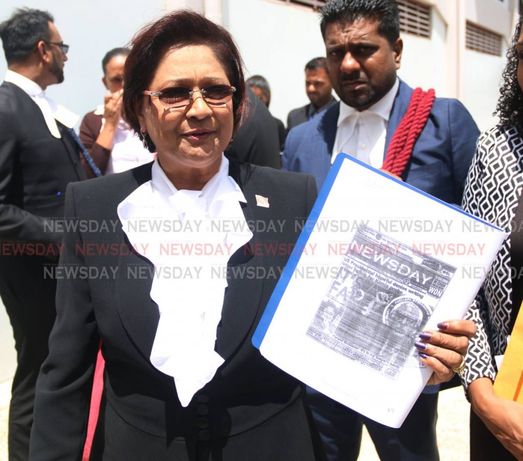 Oppostion Leader Kamla Persad-Bissessar was seen holding up the copy of a front page of Newsday which reads 