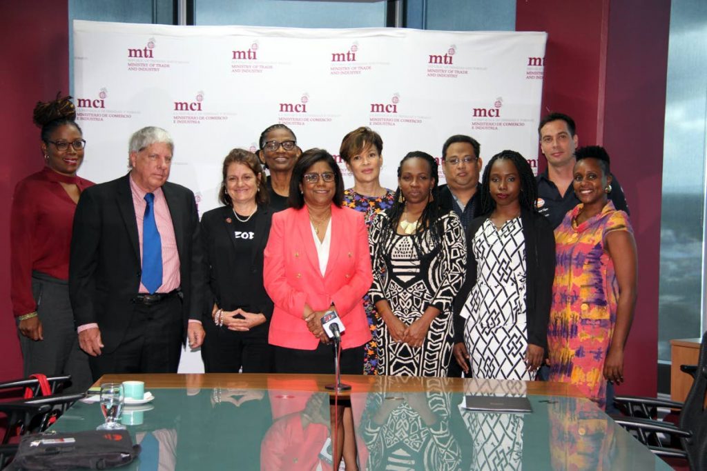 Trade Minister Paula Gopee-Scoon, front centre, along with film creators, who received rebates at the Trade Ministry at Nicolas Towers in Port of Spain, Wednesday.