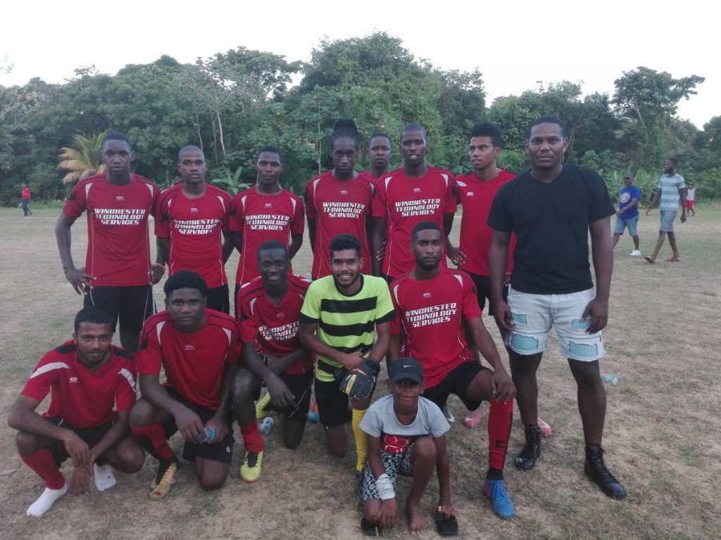 G Madrid players, fans and manager after a win earlier this season in the Caribbean Welders Fishing Pond Football League.