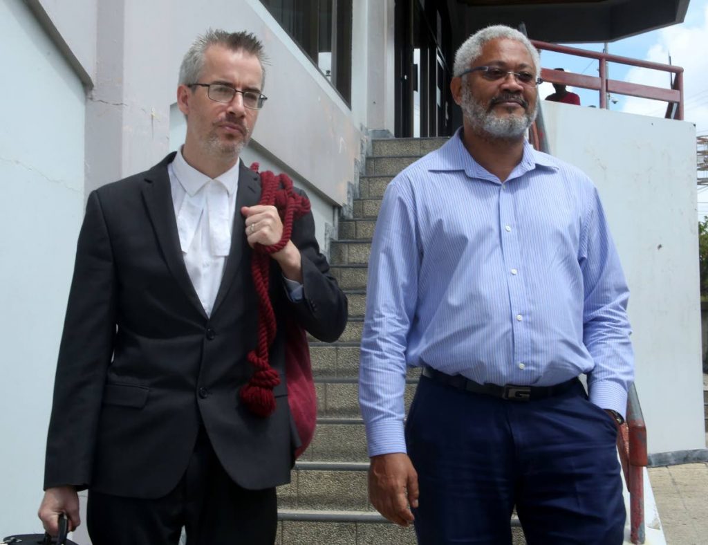 Consultant surveyor Afra Raymond leaves San Fernando High Court this morning with his attorney Kingsley Walesby after winning the right to have information on government's deal with Sandals resort. Photo by Vashti Singh