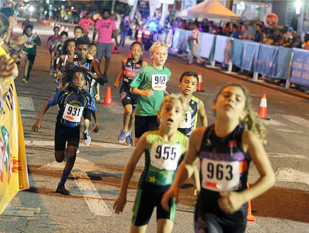 Young athletes compete during the duathlon segment of the Beacon Cycling on the Avenue Seven at Ariapita Avenue in Woodbrook, on Wednesday night.