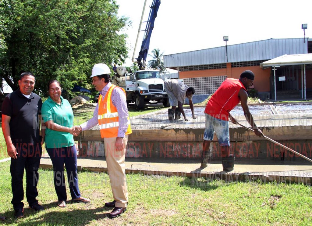 MUSIC TO THEIR EARS: Madras Government Primary School Principal Cherryann Drakes (centre) and vice principal Devanand Maharaj thank Coosal's Chairman Sieunarine Coosal as work continued last Friday on the school's new music room. PHOTO SUREASH CHOLAI
