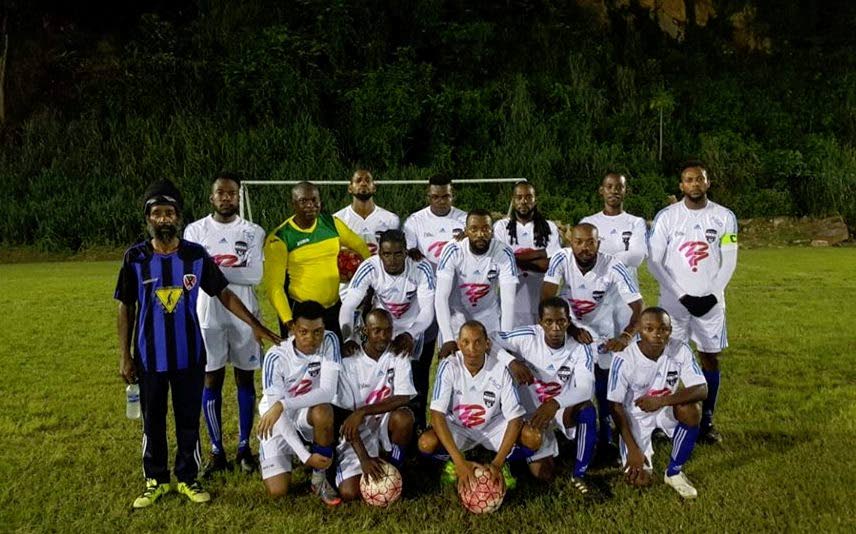 Head coach Cedric Hazelwood (left) with members of the Miscellaneous Laventille United team at its home ground in Sogren Trace, on Friday night.