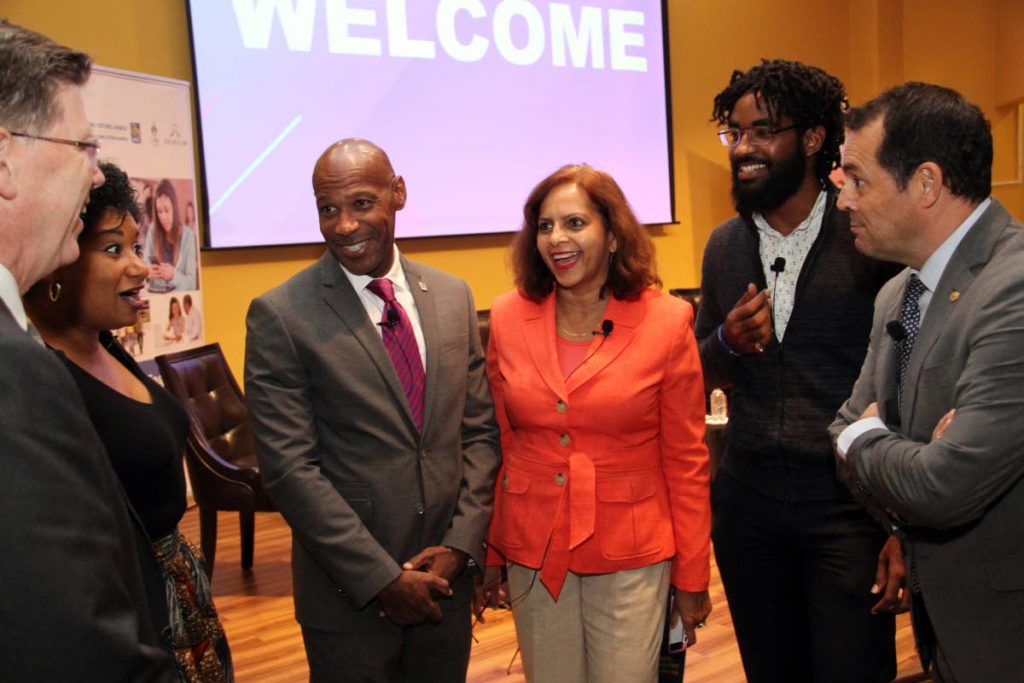LAUGHING MATTER: Darryl White - CEO of RBC Financial (third from left), shares a light moment with (from left) RBC’s Head of Caribbean Banking Rob Johnston, Nadella Ava, Kamla Mungal, youth activist Nikoli Edwards and Head of Marketing at Nestle Caribbean Patricio Torres.     PHOTO BY SUREASH CHOLAI