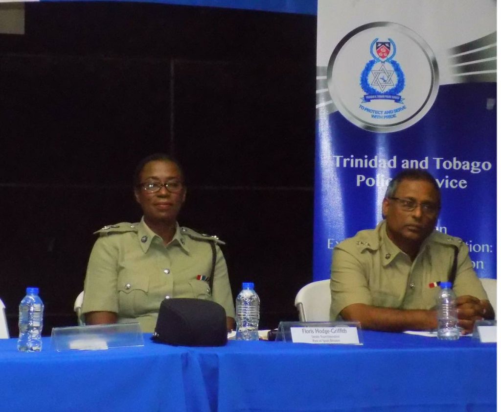 Snr Supt of Port of Spain Division Floris Hodge-Griffith, left and Supt Dale Ablack listen to residents during a police town hall meeting in Rock City, Laventille last night. 