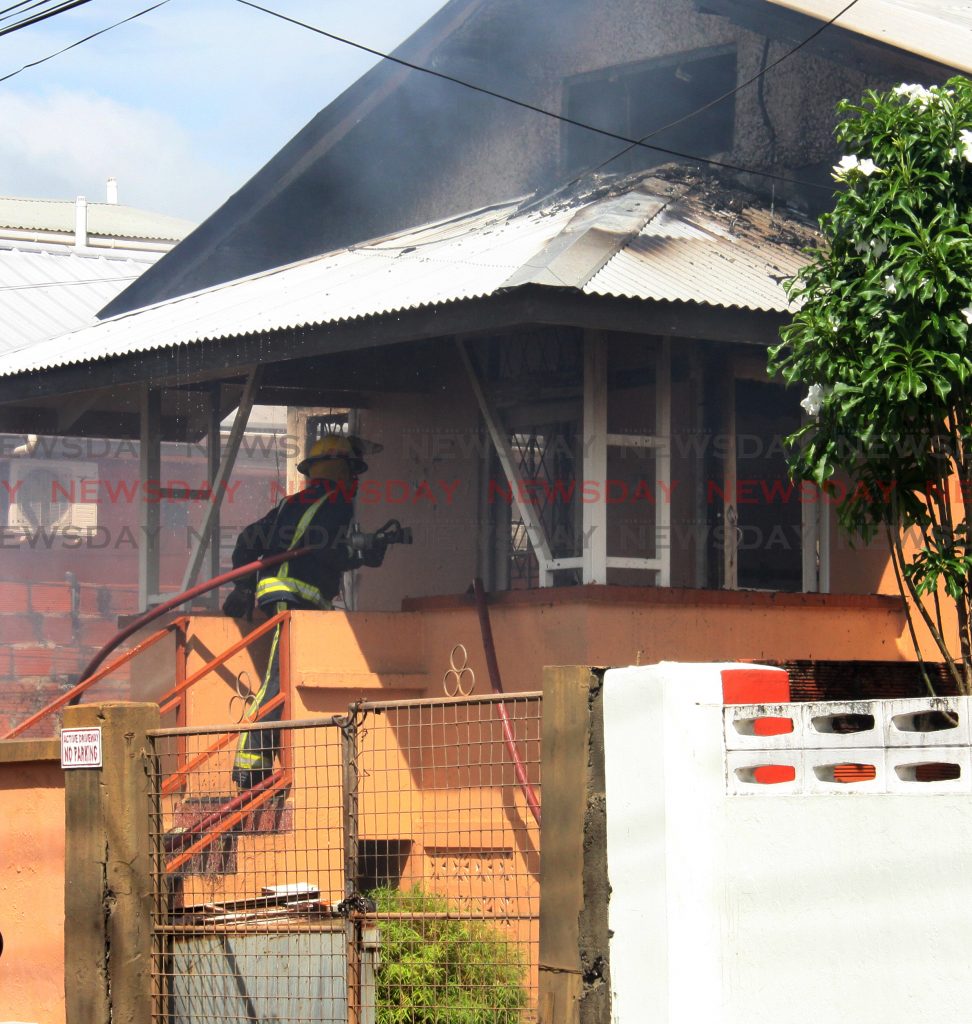 A member of the Trinidad & Tobago Fire sevice, enters a burning house on Gallus Street, Woodbrook.

PHOTO:ANGELO M. MARCELLE
16-10-2018