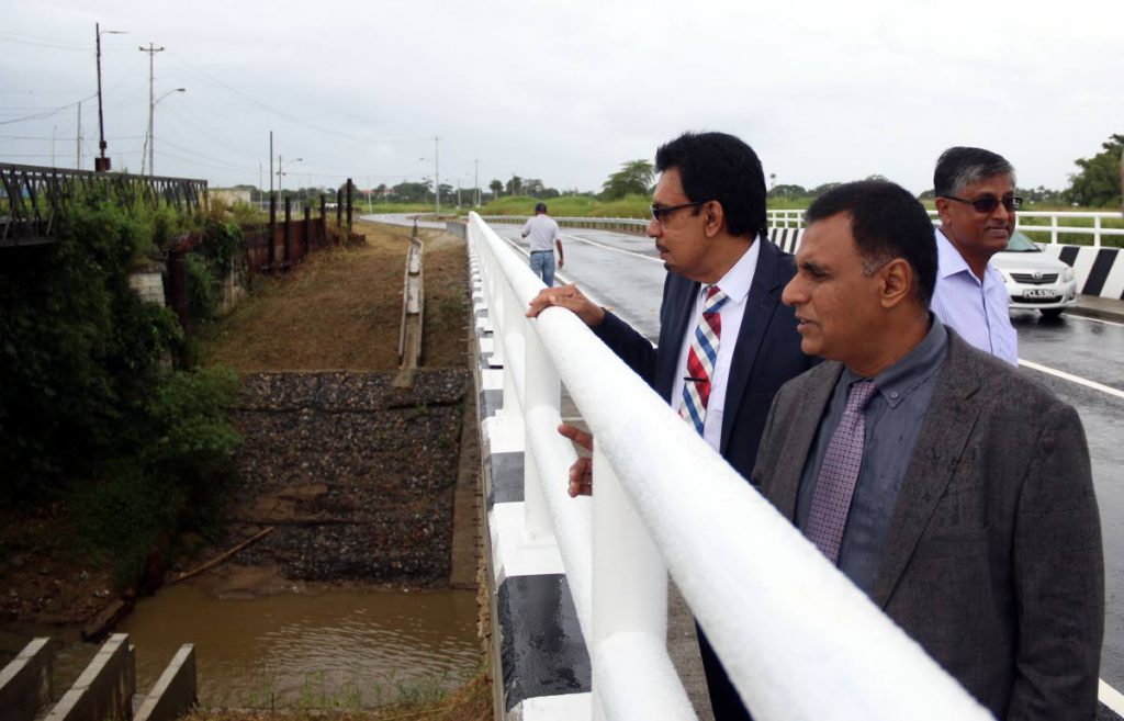 FLASHBACK: Minister of Works and Transport Rohan Sinanan along with Minister of Local Government and Rural Develpoment Kazim Hosein looking on at works done after the opening of the Camden Road Bridge. PHOTO BY ANSEL JEBODH