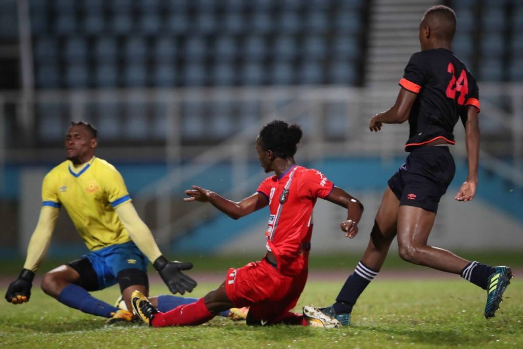 Morvant’s Sheldon Holder (center) has his shot saved by North East Stars goalkeeper Glenroy Samuel while defender Rakim Cabie (#24) looks on, during the rescheduled TT Pro League Round 1, Match Day 4 between Morvant Caledonia United and North East Stars at the Ato Boldon Stadium, Couva, on Tuesday. The game ended 0-0. Photo by Allan V. Crane/CA-images