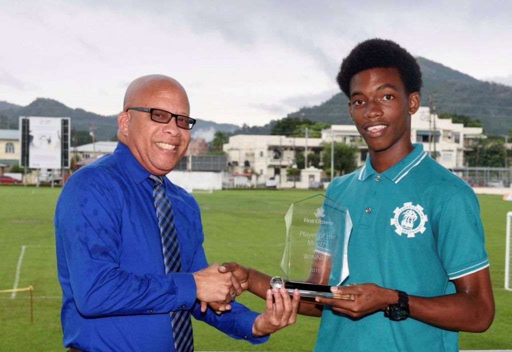 First Citizens Senior Account Manager, Commercial Business Centre, Reynold Thomas (left) presents the First Citizens September Player of the Month Award to Josiah King of Carapichaima East Secondary.