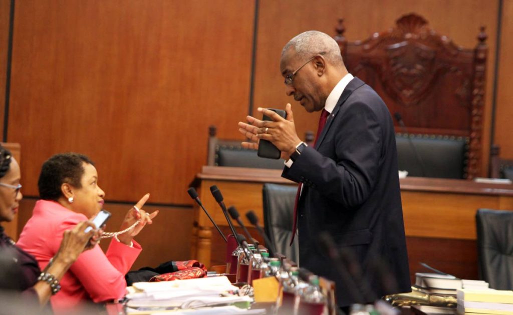 Minister in the Ministry of Finance Allyson West speaks with Public Utilities Minister Robert Le Hunte during a break in yesterday’s Senate debate on the budget.