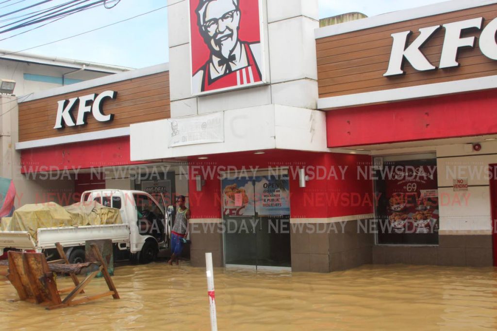 Floodwaters did not spare KFC in the heart of the central business district of Sangre Grande yesterday. PHOTO BY ENRIQUE ASSOON