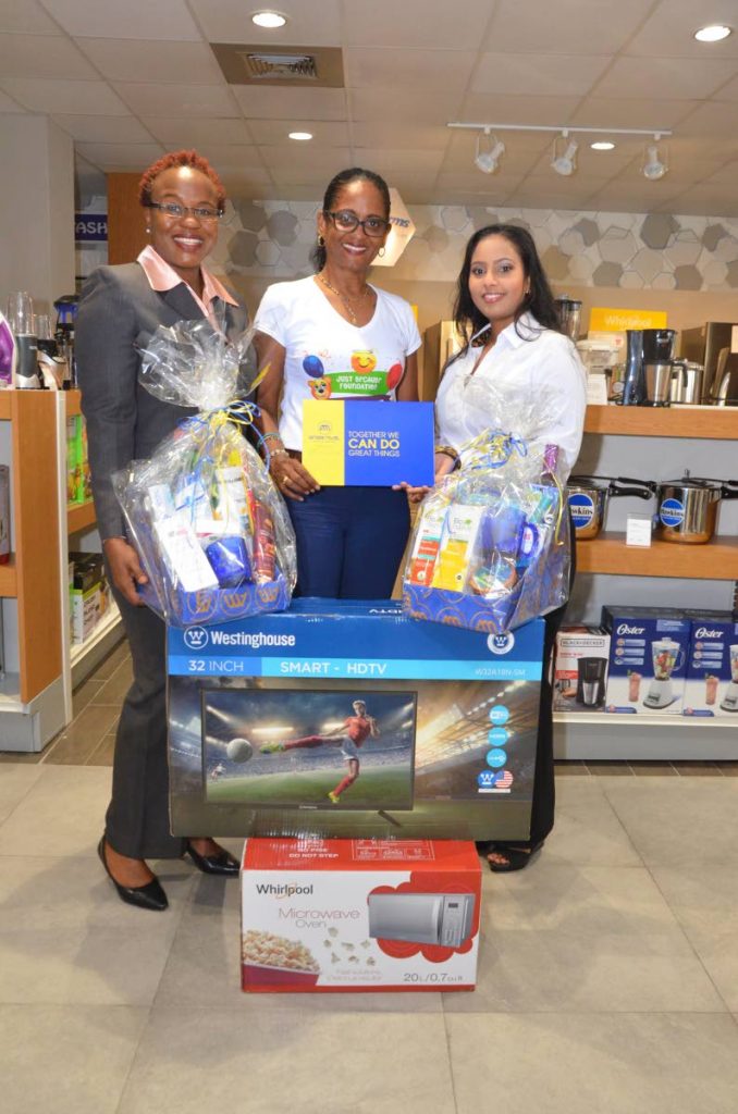Nataki Kerr, marketing manager, Standard Distribution Ltd; Chevaugn Joseph, founder of the Just Because Foundation; and Natasha Ramnath, ANSA McAL Group corporate communications officer during the presentation at the Standard’s store on the corner of Queen and Henry streets, Port of Spain.