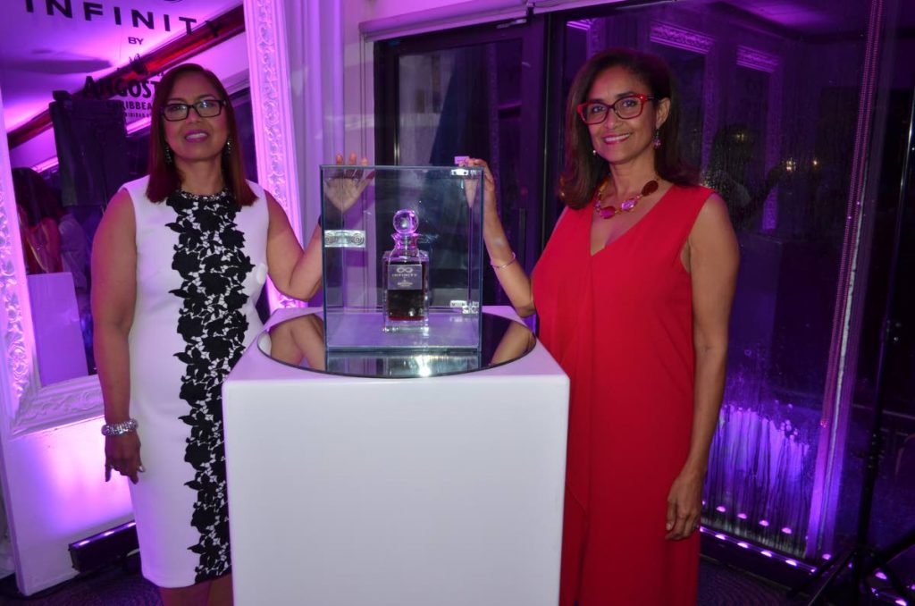 Angostura's master blender Carol Homer-Caesar left, and Manager – Hospitality and Communications Giselle La Ronde show off the bottle of Infinity