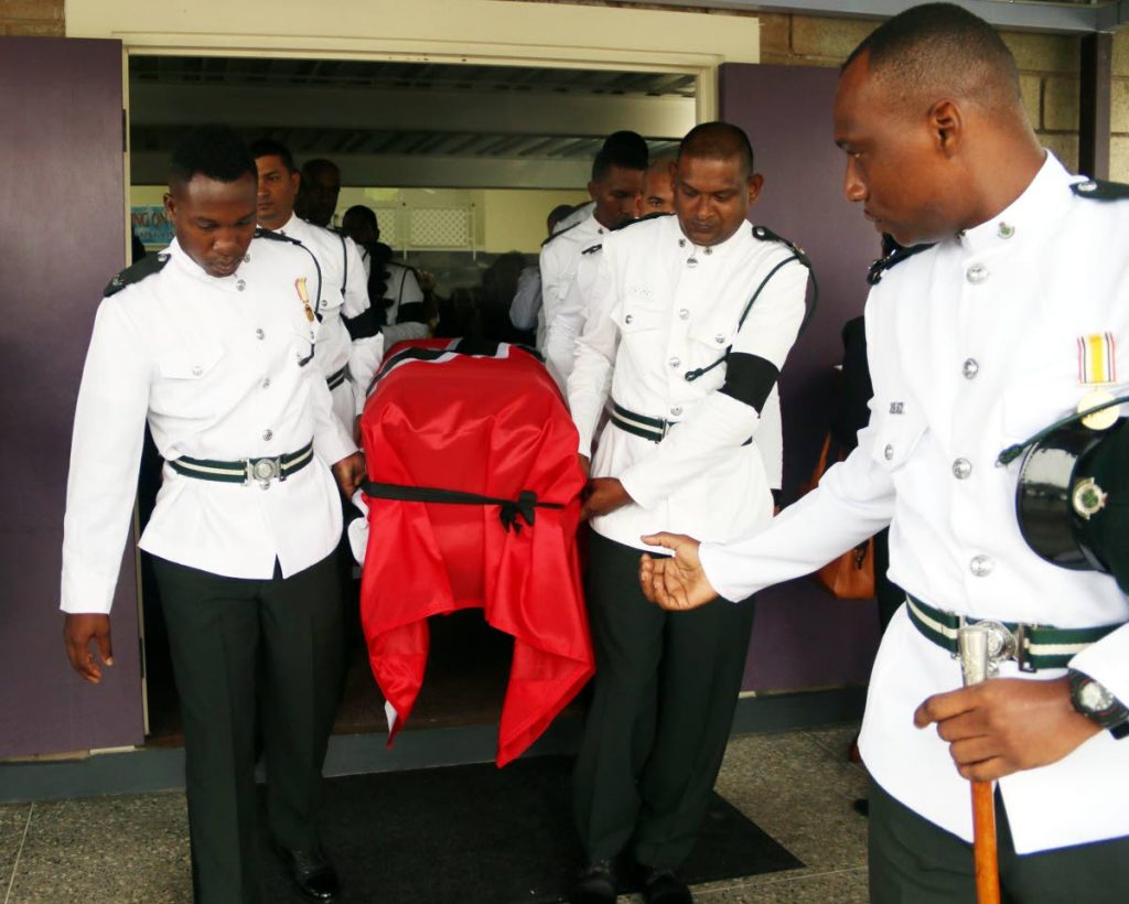 Prisons officers carry the casket of prison officer Darren Francis at his funeral service yesterday.