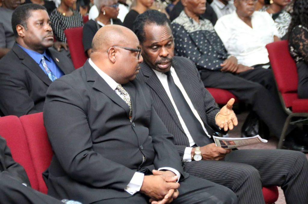 Acting Attorney General Fitzgerald Hinds (right) with acting Commissioner of Prisons Dane Clarke at the funeral service of Prison Officer Darren Francis who was shot and killed last week at his Princes Town home.