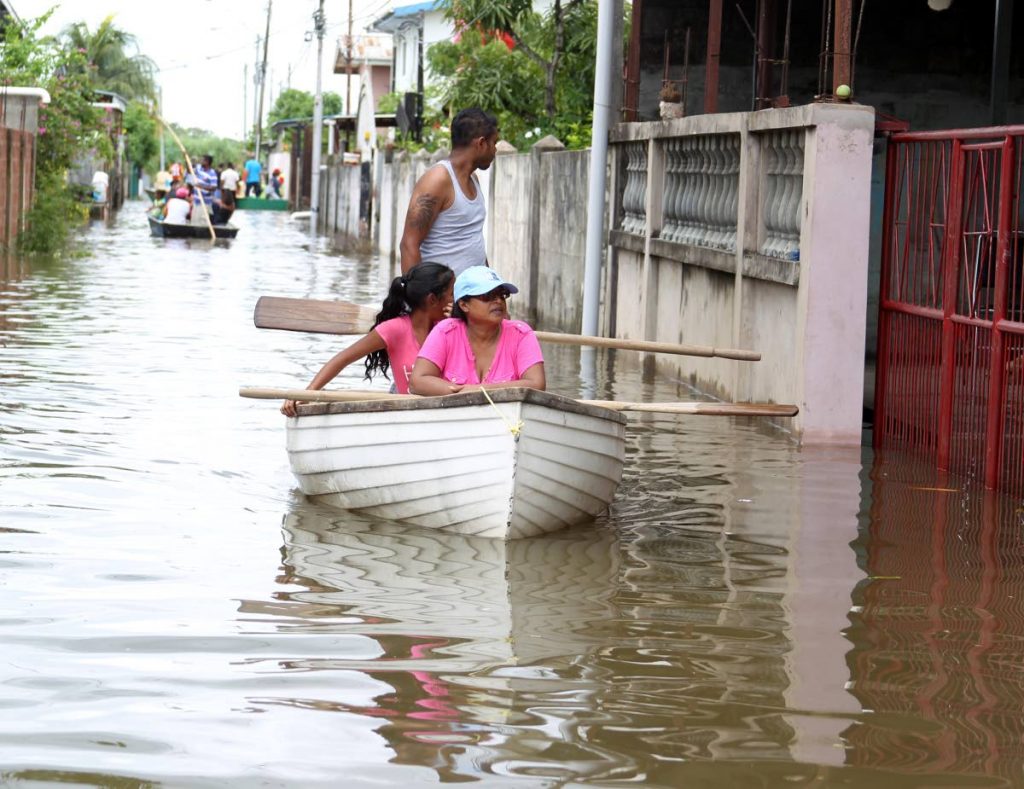 Surveying the damage, residents who mobilised themselves with boats and relief items come to the aid of their neighbours of the El Socorro South community on October 23.