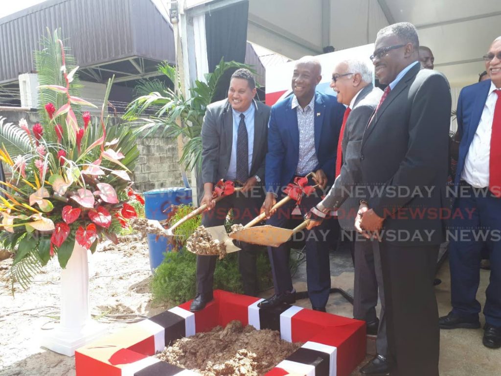 SHOVELING DIRT: Prime Minister Dr Keith Rowley (second from left) is assisted by Diego Martin Central MP Darryl Smith and Health Minister Terrence Deyalsingh with turning the sod for a new Diego Martin health centre at Wendy Fitwilliam Boulevard on Wednesday morning. Looking on is Housing Minister Edmund Dillon.  PHOTO BY KALIFA CLYNE
