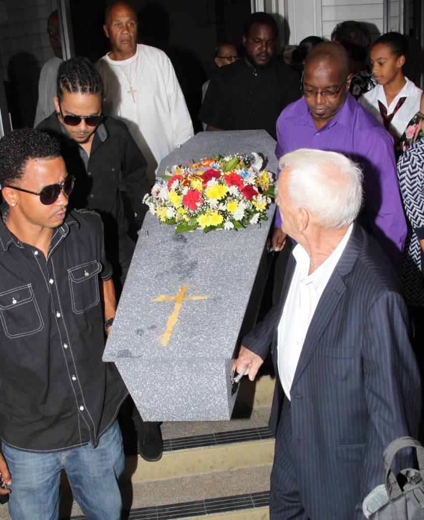 FINAL FAREWELL: Pallbearers carry the casket of fomer TT Triathlon Federation president and journalist Ian Gooding following the funeral service for him held on Thursday at The Church of the Nativity, Diego Martin.