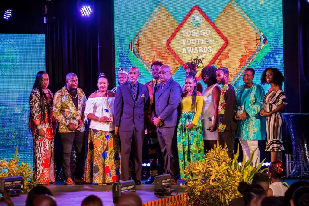 Chief Secretary Kevin Charles, right front, and Secretary of Sport and Youth Jomo Pitt, left front, with winners of the Tobago Youth Awards held at the Magdalena Grand Beach and Golf Resort.