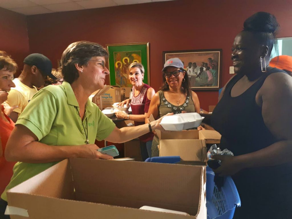Assistant director of Living Water Community Rosemarie Scott and Sharon Sandy happily package food for distribution.

Photo: Marshelle Haseley
