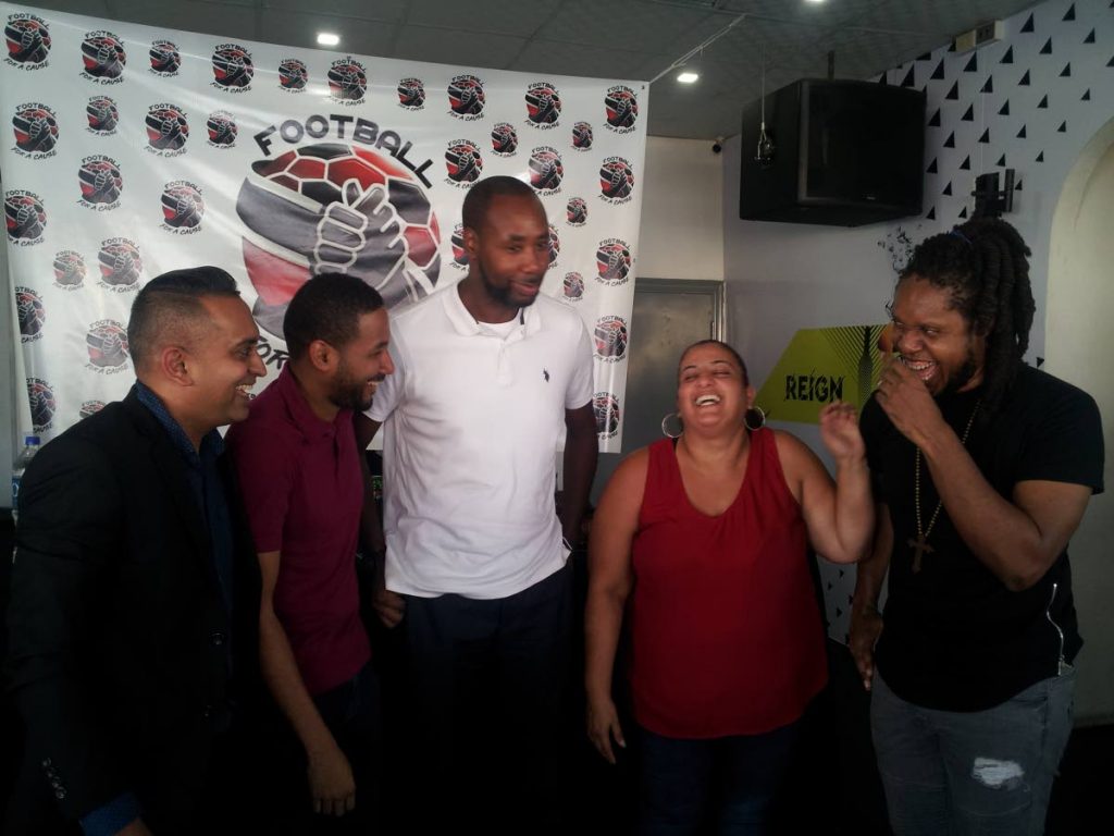 MX Prime, right, shares a light moment with other organisers of the Football For a Cause relief football match at #63 Bar in Woodbrook, yesterday. Also in the photograph are (from left) Shaun Fuentes, director of communications at the TT Football Association, Kyle Lequay, sports marketing consultant, TT men’s football coach Dennis Lawrence and assistant secretary general of the TT Olympic Committee Nadine Khan.