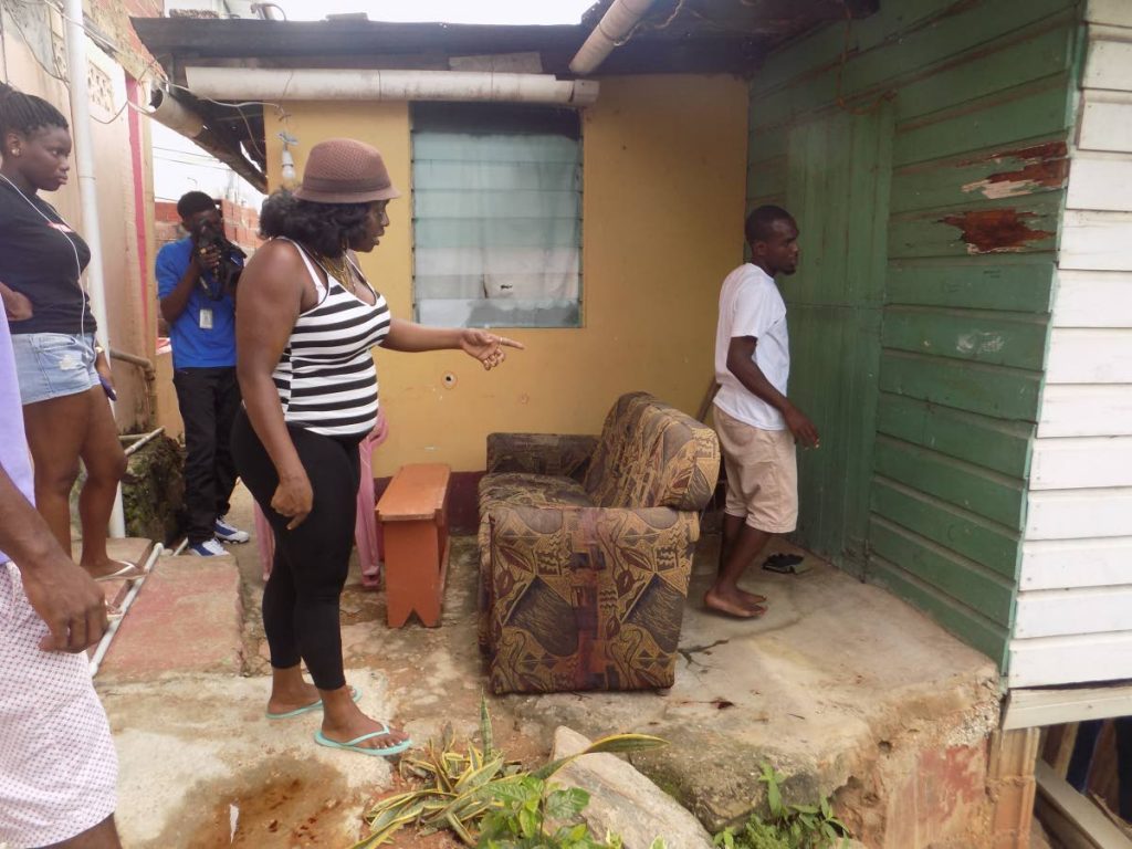 Relatives of 15-year-old schoolboy Shekeem Francois count the bullets at the back of the family's Trou Macaque, Laventille, home. Photo by SHane Superville