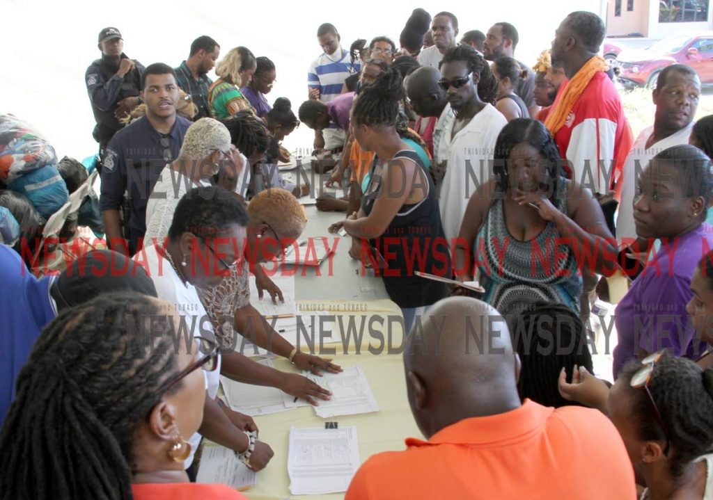 Residents wait to hear their names called to receive flood relief grants at Greenvale Park, La Horquetta in October. Grants were also issued in Sangre Grande and Mafeking, Mayaro. PHOTO BY ROGER JACOB