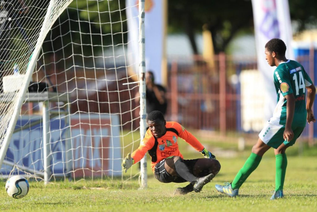 Moka’s goalkeeper Nathaniel Thomas reaches in vain to save the opening goal from Trinity East’s Jaden Mckree (not pictured), also pictured is Moka’s Abdul Lezama (#14), during Match day #12 of the SSFL between Trinity College (East) and Trinity College (Moka) at Trinity East Grounds, Trincity,yesterday. The game ended 1-1. Photo by Kerlon Orr/CA-images