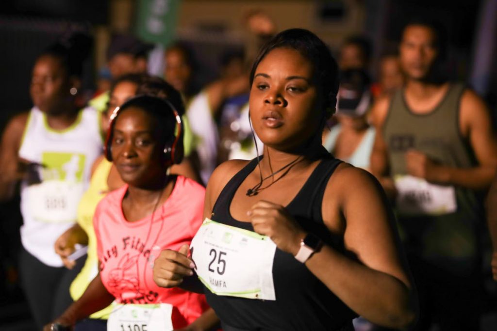 Minister of Sport and Youth Affairs Shamfa Cudjoe takes part in the UWI SPEC International Half Marathon, on Sunday.