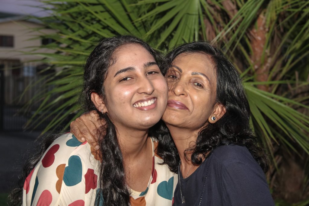 HAPPINESS IS: President's Medal scholarship winner Amrita Singh with her mom Maria at their Cunupia home, yesterday.  Photo by Jeff K.Mayers 