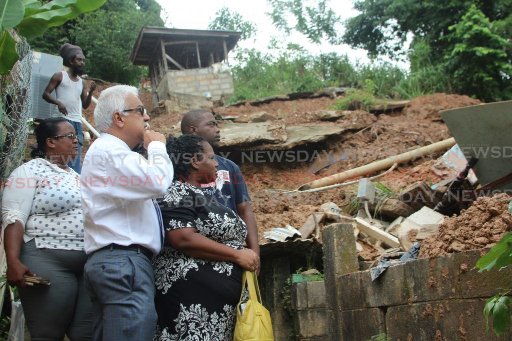 Minister of Health Terrence Deyalsingh visited the McKain family yesterday and their house fell during a landslide on Mt Lambert .
Photo by Enrique Assoon