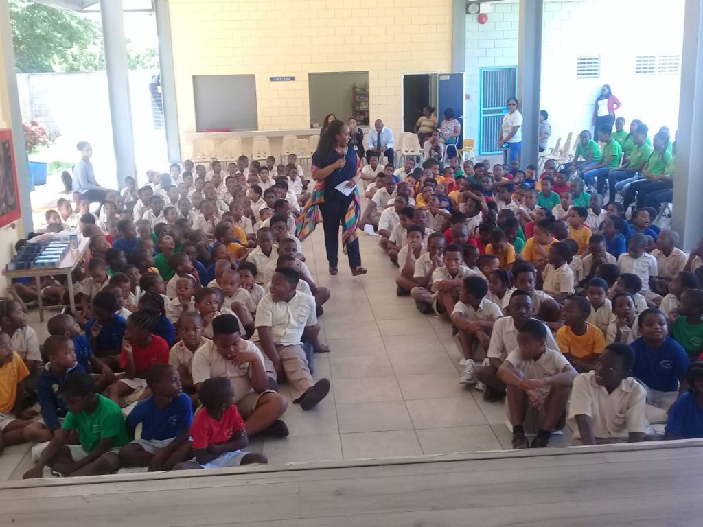 Bridge Foundation CEO Anthea McLaughlin speaks to students at Belmont Boys† RC School on Read for the Record Day, on October 25. PHOTO BY MARLENE AUGUSTINE