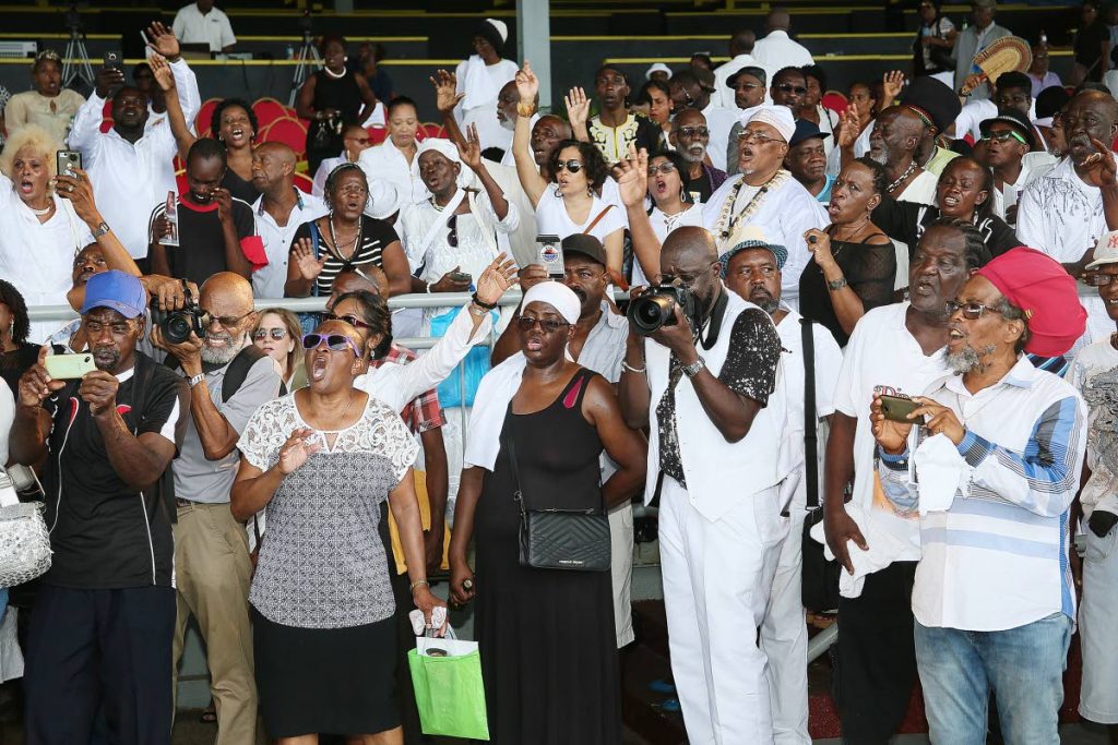 SINGING HIS PRAISE: A cross-section of the crowd at Winston “Shadow” Bailey’s  life achievement tribute, Queen’s Park Savannah. Port of Spain.  
Singing along were a large crowd
PHOTO BY AZLAN MOHAMMED