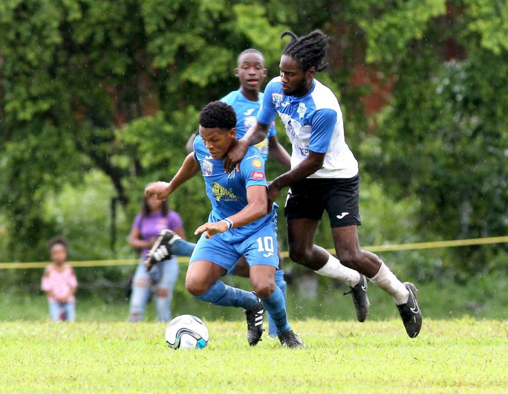 Naparima College  player Decklan Marcelle and  Aleem Barclay of Presentation College San Fernando vie for the ball during thew SSFL clash at Naparima’s Grounds, Lewis Street, San Fernando.