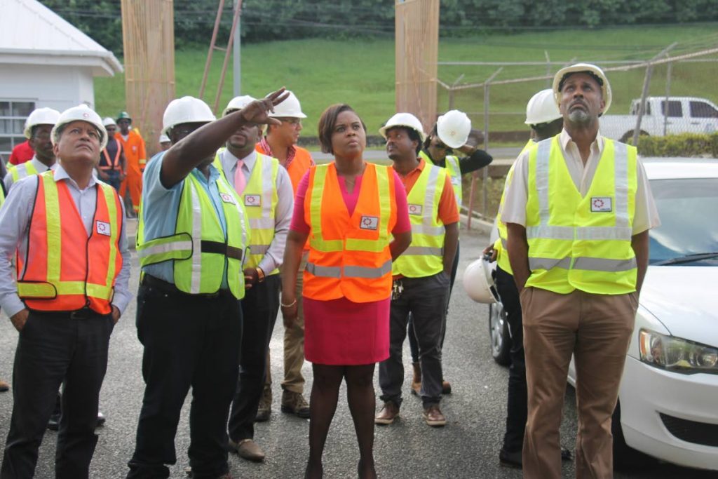 Project Manager Mc Jasse Salino points to the ongoing works at the Dwight Yorke Stadium, as Minister of Sport and Youth Affairs Shamfa Cudjoe (centre) and officials from THA, SPORTT and UDECOTT tour the facility on Tuesday.