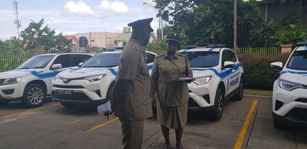 TALKING TOUGH: Ag Supt Tobago, Jeffrey George, chats with ACP Tobago, Sharon Blake-Clarke at the blessing of four new vehicles assigned to the new Emergency Response Unit at the Agricultural Development Bank Building in Scarborough on Friday. 