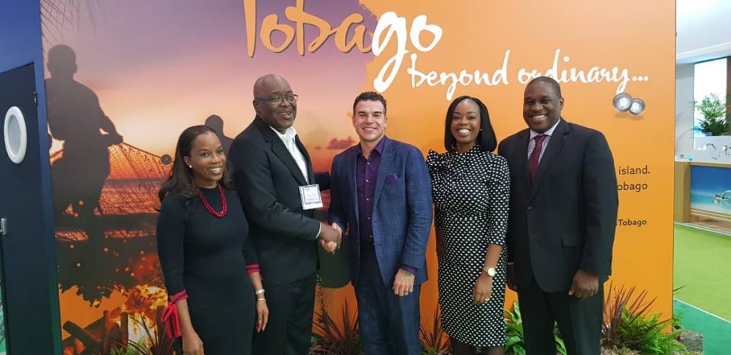 Dr Sherma Roberts, Chairman of Tobago Tourism Agency Ltd (TTAL), left, smiles as Chief Secretary Kelvin Charles, second from left, shakes the hand of Eric Rodriguez, Executive Vice President of Partner Development Tour Operations, Sunwing, as Tourism Secretary Nadine Stewart-Phillips, second from right, and Louis Lewis, CEO of TTAL look on at World Travel Market on Tuesday in London. 