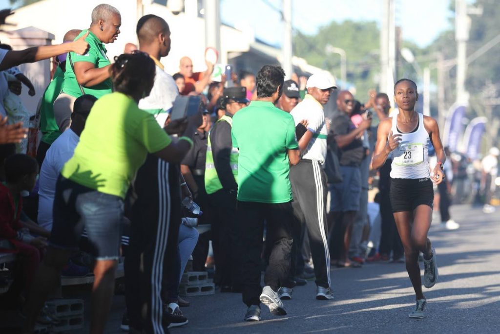 SAMANTHA SHUKLA crosses the finish line at the University of the West Indies’ (UWI) SPEC International Half Marathon on October 28.