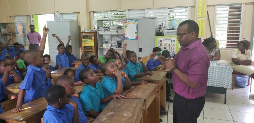 Motivational speaker Michael Stewart, right, chats with boys from Montgomery Government primary school during the MACHO man programme organised by the THA. 