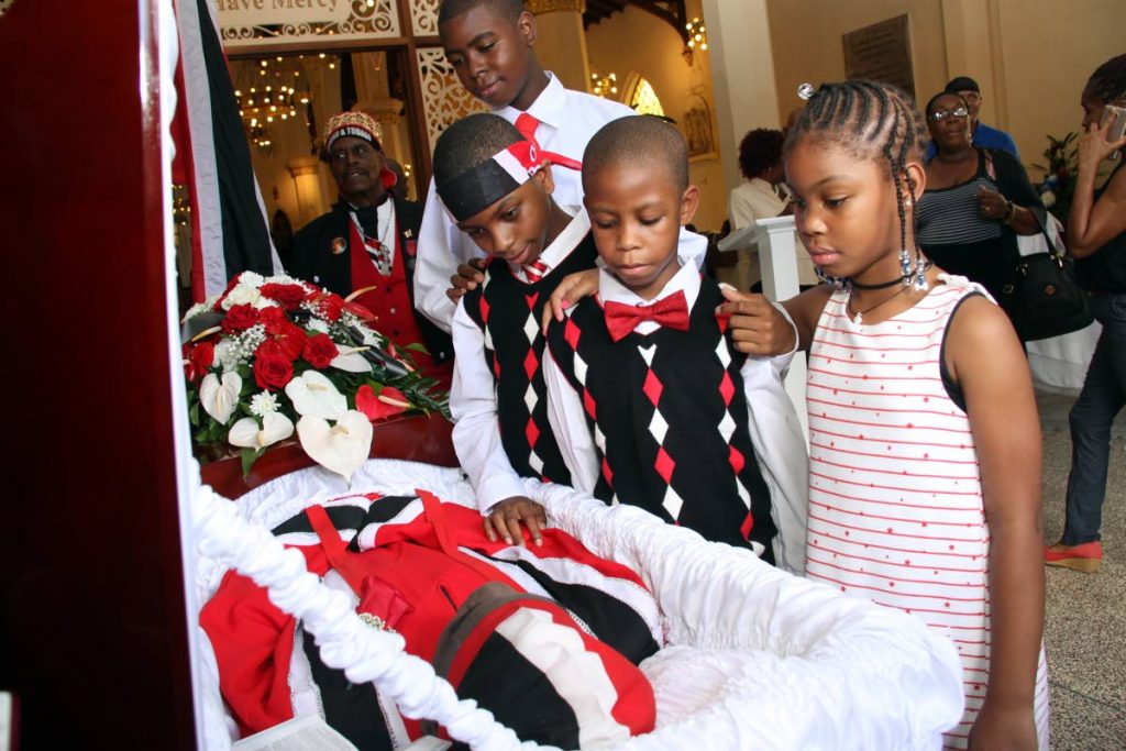 BYE GRANDPA: (from left) Zaid, Zakr, Zair and Zariah say farewell to their grandfather Winston Scarborough - The Original De Fosto Himself at the RC Cathedral of the Immaculate Conception yesterday.   PHOTO BY SUREASH CHOLAI